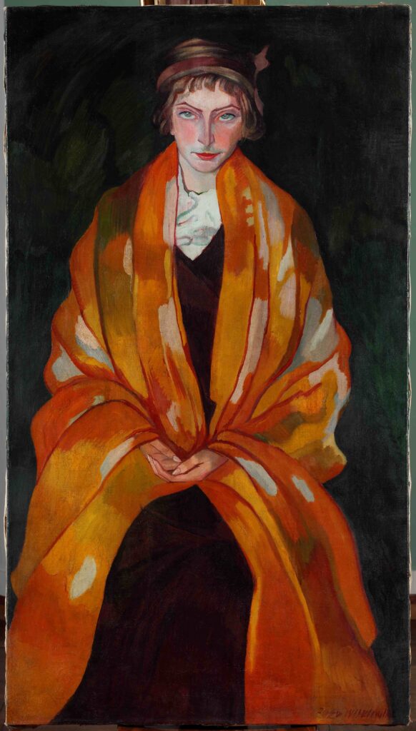 portret kobiety w czerwono - pomarańczowym kocu